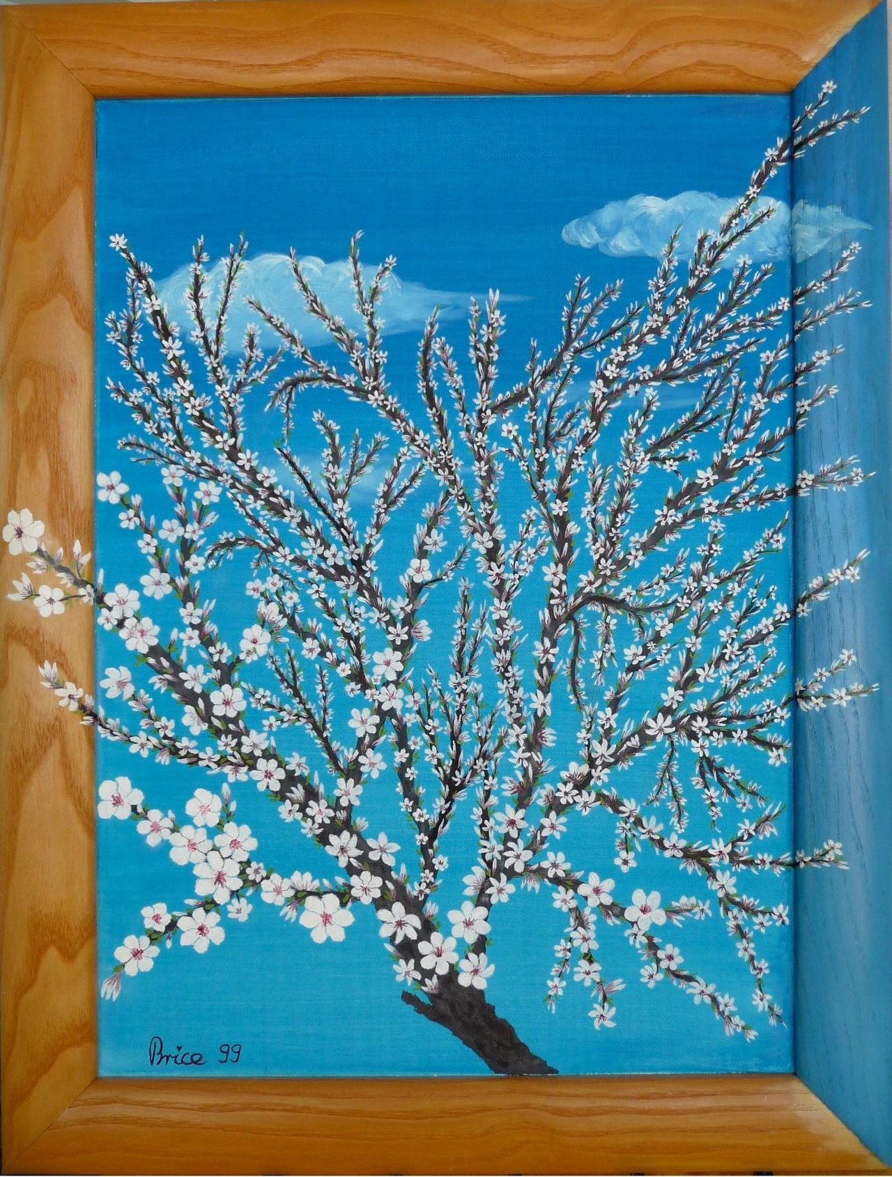 Blühender Mandelzweig mit weißen Blüten vor leuchtend blauem Himmel.